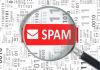 lente ingrandimento con scritta spam e codice